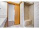 The bathroom features a tile shower with a bench and sliding door at 3948 S Halifax St, Aurora, CO 80013