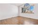 A bedroom boasts laminate floors and a large arched window at 3948 S Halifax St, Aurora, CO 80013