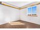 Inviting bedroom featuring wood floors and a large window offering ample natural light at 3948 S Halifax St, Aurora, CO 80013