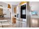 Modern kitchen showcasing stainless steel appliances, an island and an open view to the living spaces with hardwood floors at 3948 S Halifax St, Aurora, CO 80013
