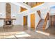Inviting living area features a stone fireplace, high ceilings, new flooring and an open staircase to the second floor at 3948 S Halifax St, Aurora, CO 80013