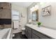 Bright bathroom with a marble countertop, framed mirror, and tiled shower at 2857 Xanthia Ct, Denver, CO 80238