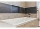 A modern drop-in tub with tile surround and built-in niche create a relaxing bathroom at 2857 Xanthia Ct, Denver, CO 80238