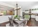 Open concept dining room that flows into a kitchen with stainless appliances and wood floors at 2857 Xanthia Ct, Denver, CO 80238