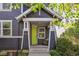 Inviting home entrance with a charming front porch featuring a lime green front door and cozy outdoor seating at 2857 Xanthia Ct, Denver, CO 80238