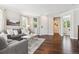 Cozy living room with hardwood floors, neutral-toned furniture, and seamless transition to adjoining rooms at 2857 Xanthia Ct, Denver, CO 80238
