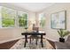 Bright office space with three windows, modern desk, rug, and neutral color scheme at 2857 Xanthia Ct, Denver, CO 80238