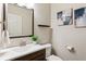 Stylish powder room featuring a modern vanity, sleek fixtures, and decorative artwork at 2857 Xanthia Ct, Denver, CO 80238