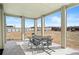 Covered patio with a table and chairs and a view of the large backyard at 16378 Lamb Ave, Fort Lupton, CO 80621