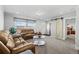 Cozy living room featuring leather sofas, stylish decor, and a sliding barn door at 16378 Lamb Ave, Fort Lupton, CO 80621