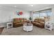 Comfortable living room with plush leather seating, decorative accents, and a large window at 16378 Lamb Ave, Fort Lupton, CO 80621