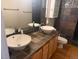 Bathroom featuring double sinks, decorative backsplash and modern fixtures at 1555 California St # 609, Denver, CO 80202