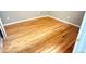 This empty bedroom features hardwood floors and neutral paint at 1555 California St # 609, Denver, CO 80202
