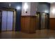 Building elevators with wooden accents, wood flooring and neutral paint scheme at 1555 California St # 609, Denver, CO 80202