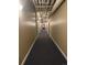 A long hallway with neutral walls and blue carpet that runs all the way down the hall at 1555 California St # 609, Denver, CO 80202