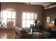 Bright living room with large windows, modern shutters, ceiling fan and stylish furniture at 1555 California St # 609, Denver, CO 80202