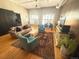 Open living room area with hardwood floors, cozy furniture, and bright natural lighting at 1555 California St # 609, Denver, CO 80202