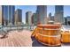 Rooftop deck with hot tub, lounge seating and city views at 1555 California St # 609, Denver, CO 80202