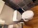 Close-up of toilet in a bathroom with matching tile and modern fixtures at 1555 California St # 609, Denver, CO 80202
