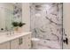 Bathroom featuring marble shower, glass partition, and vanity with contemporary fixtures and hardware at 2821 E Cedar Ave # 14, Denver, CO 80209