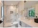 This bathroom features a marble tile shower, glass partition, and vanity with a contemporary faucet at 2821 E Cedar Ave # 14, Denver, CO 80209
