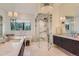 Elegant bathroom with marble countertops, mosaic floors, a glass-enclosed shower, and soaking tub at 2821 E Cedar Ave # 14, Denver, CO 80209