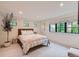Bright bedroom with neutral decor, large windows, and recessed lighting exudes warmth and comfort at 2821 E Cedar Ave # 14, Denver, CO 80209