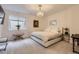 Bright bedroom features neutral decor, a modern chandelier and bedside table at 2821 E Cedar Ave # 14, Denver, CO 80209