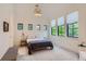 Minimalist bedroom with a modern light fixture and large windows at 2821 E Cedar Ave # 14, Denver, CO 80209