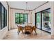 Bright dining area with wood floors and modern decor open to outdoor living area at 2821 E Cedar Ave # 14, Denver, CO 80209