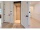 Hallway featuring a wood paneled elevator with modern hardware, and light hardwood flooring at 2821 E Cedar Ave # 14, Denver, CO 80209