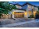 Beautiful home with a wooden garage door and appealing architectural details at dusk at 2821 E Cedar Ave # 14, Denver, CO 80209