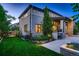 Elegant two-story home with manicured lawn, mature trees, and outdoor kitchen, showcasing its curb appeal at 2821 E Cedar Ave # 14, Denver, CO 80209