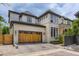 Beautiful home with a wooden garage door, paver driveway, and appealing architectural details at 2821 E Cedar Ave # 14, Denver, CO 80209