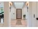 Elegant foyer featuring hardwood floors, modern lighting, a grand piano, and access to an elevator at 2821 E Cedar Ave # 14, Denver, CO 80209
