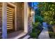 Striking modern front door with stone facade and manicured landscaping under evening lights at 2821 E Cedar Ave # 14, Denver, CO 80209