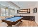 Game room features a pool table, wet bar, under counter refrigerator, and built-in display shelves at 2821 E Cedar Ave # 14, Denver, CO 80209