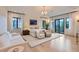 Bright main bedroom with hardwood floors, balcony access, and modern chandelier lighting at 2821 E Cedar Ave # 14, Denver, CO 80209