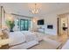 Bright main bedroom boasts a balcony, a flat screen television, and an electric fireplace at 2821 E Cedar Ave # 14, Denver, CO 80209