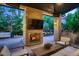 Inviting outdoor living space with stone fireplace, plush seating, and a built-in grill, perfect for entertaining at 2821 E Cedar Ave # 14, Denver, CO 80209