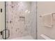 This walk-in shower features hexagon pattern tiling, rain shower head, and integrated shelving niche at 2821 E Cedar Ave # 14, Denver, CO 80209