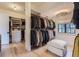 Bright walk-in closet with custom organization, plenty of hanging space, and hardwood floors at 2821 E Cedar Ave # 14, Denver, CO 80209