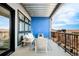 Comfortable balcony featuring outdoor seating, city views, and a vibrant blue accent wall at 3198 Blake St # 402, Denver, CO 80205