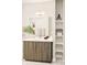 Modern bathroom with a wood-grain vanity, ample counter space, and built-in shelving for storage at 3198 Blake St # 402, Denver, CO 80205