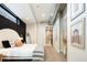 Modern bedroom with minimalist decor and a view to the ensuite bath at 3198 Blake St # 402, Denver, CO 80205