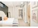 Stylish bedroom with a sleek design featuring a modern bed, minimalist decor, and an ensuite bathroom at 3198 Blake St # 402, Denver, CO 80205