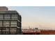 View of a modern building with mountain views in the distance, combining urban and natural scenery at 3198 Blake St # 402, Denver, CO 80205