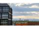 View of city architecture and snow capped mountains in the distance at 3198 Blake St # 402, Denver, CO 80205