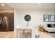 Modern dining space featuring a light wood table, and neutral decor, seamlessly connected to the living area at 3198 Blake St # 402, Denver, CO 80205