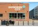 Improper City business exterior with a motorcycle, brick building, and surrounding city street view at 3198 Blake St # 402, Denver, CO 80205
